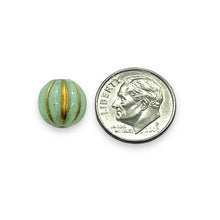 Load image into Gallery viewer, Czech glass round melon beads 15pc mint green gold 10mm UV reactive
