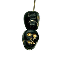 Load image into Gallery viewer, Czech glass skull beads 8pc matte black gold 12mm
