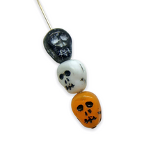 Load image into Gallery viewer, Czech glass skull shaped beads 12pcs Halloween colors mix orange black white
