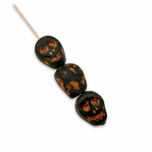 Load image into Gallery viewer, Czech glass Halloween skull beads 8pc opaque black orange patina 12mm
