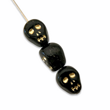 Load image into Gallery viewer, Czech glass skull beads 8pc shiny black gold decor 12mm
