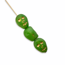 Load image into Gallery viewer, Czech glass Halloween skull beads 8pc green opal gold 12mm-Orange Grove Beads
